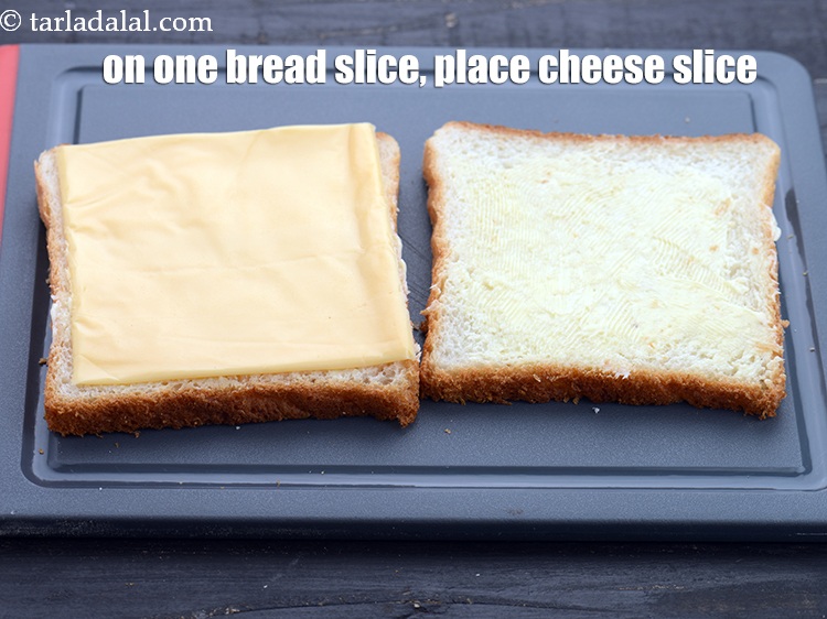 Step 5 – On one bread slice, place a <a href="https://www.tarladalal.com/glossary-cheese-slices-765i">cheese slice</a>.