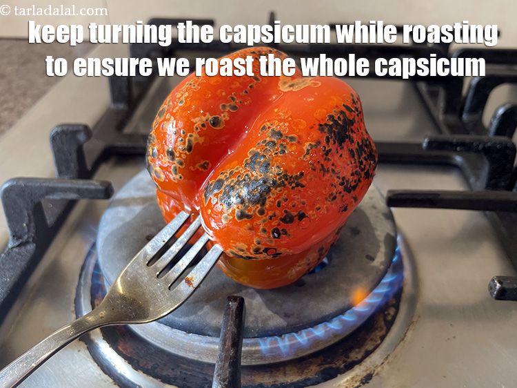 Step 9 – Keep turning the capsicum while roasting. This will ensure uniform roasting.&nbsp;