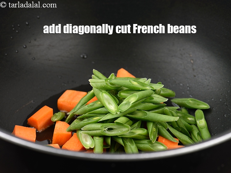 Step 6 – Add 1/2 cup&nbsp;<a href="https://www.tarladalal.com/glossary-diagonally-cut-french-beans-2461i">diagonally cut french beans</a>.