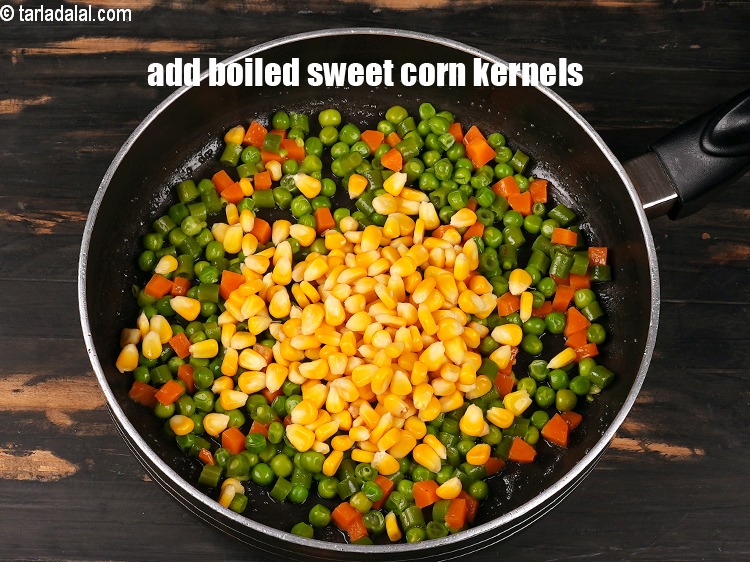 Step 6 – Add &frac12; cup <a href="https://www.tarladalal.com/glossary-boiled-sweet-corn-kernels-153i">boiled sweet corn kernels (makai ke dane)</a>..