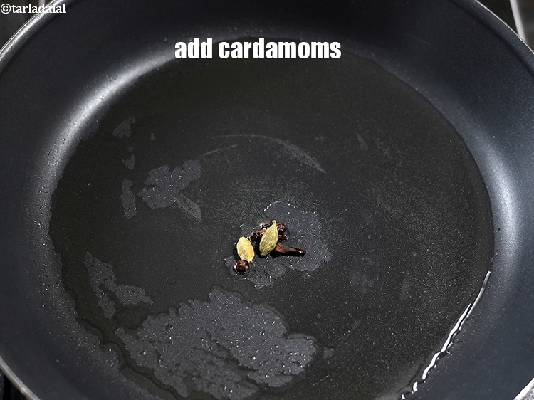 Step 10 – Add 2 <a href="https://www.tarladalal.com/glossary-cardamom-elaichi-262i">cardamoms (elaichi)</a>.