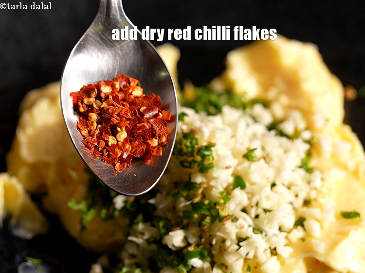 Step 6 – Add &frac12; tsp <a href="https://www.tarladalal.com/glossary-dry-red-chilli-flakes-paprika-338i">dry red chilli flakes (paprika)</a>.