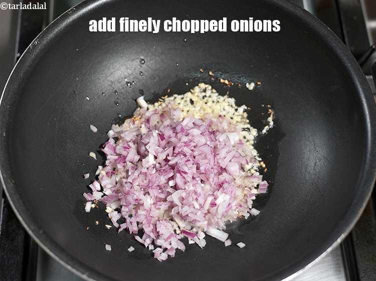 Step 6 – Add &frac12; cup finely <a href="https://www.tarladalal.com/glossary-chopped-onions-722i">chopped onions</a>.&nbsp;