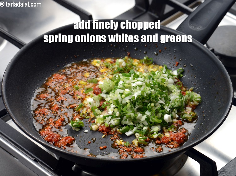 Step 6 – Add &frac12; cup finely <a href="https://www.tarladalal.com/glossary-chopped-spring-onion-whites-815i">chopped spring onions whites</a>&nbsp;and greens.