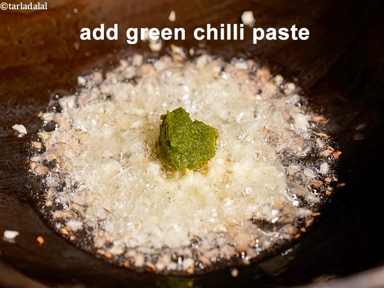 Step 9 – Add &frac12; tsp <a href="https://www.tarladalal.com/glossary-green-chilli-paste-hari-mirch-ki-paste-mirchi-paste-333i">green chilli paste</a>. See&nbsp;<a href="https://www.tarladalal.com/how-to-make-green-chilli-paste-42729r">how to make green chilli paste</a>.