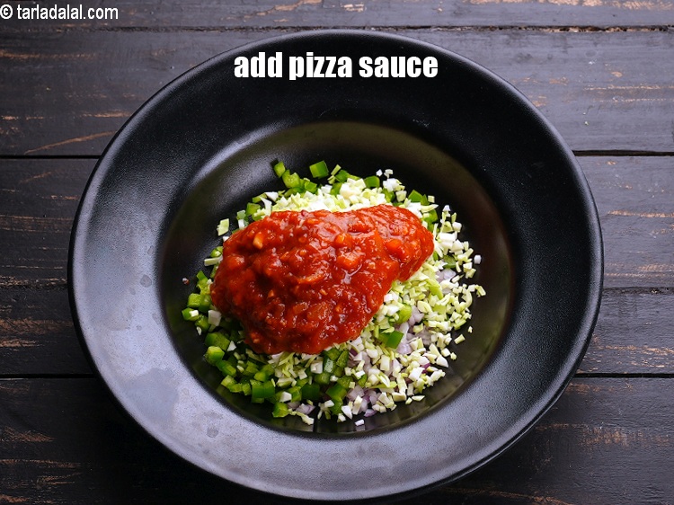 Step 6 – Add &frac14; cup <a href="https://www.tarladalal.com/glossary-pizza-sauce-1889i">pizza sauce</a>.