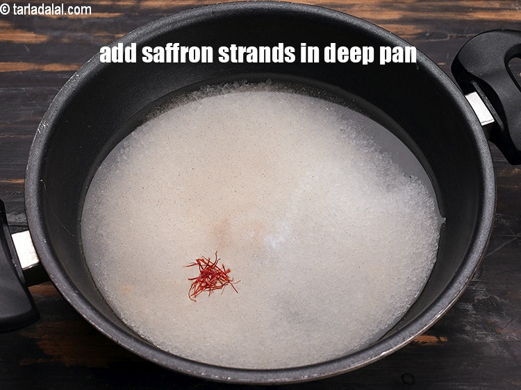 Step 7 – Add few saffron strands in a deep non-stick pan.