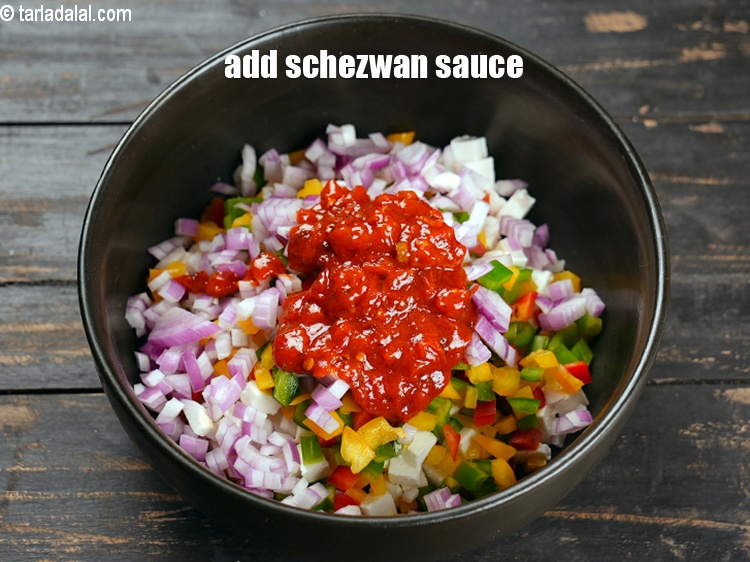 Step 7 – Add 5 tbsp <a href="https://www.tarladalal.com/glossary-schezwan-sauce-schezuan-sauce-1872i">schezwan sauce</a>.
