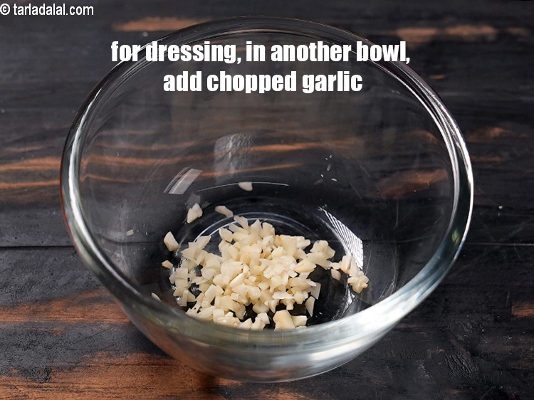 Step 6 – For the dressing, in another small bowl, add 2 tsp finely <a href="https://www.tarladalal.com/glossary-chopped-garlic-790i">chopped garlic (lehsun)</a>.