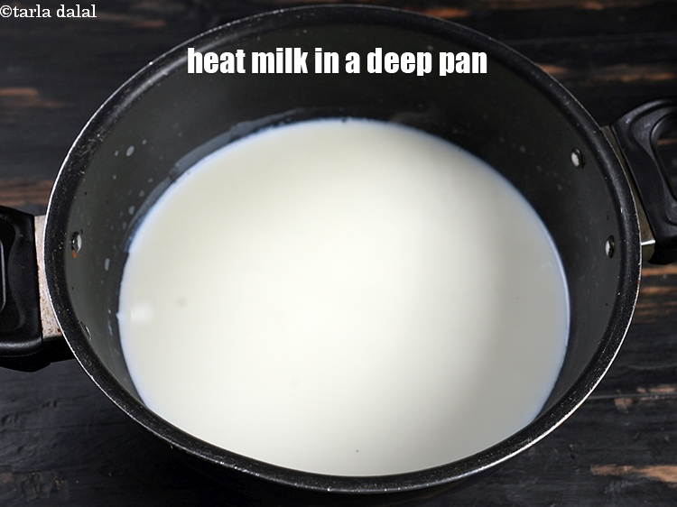 Step 6 – Heat 4 cups of milk in a deep pan.