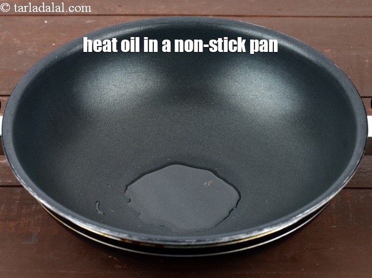 Step 6 – Heat 2 tsp oil in a deep non-stick pan.