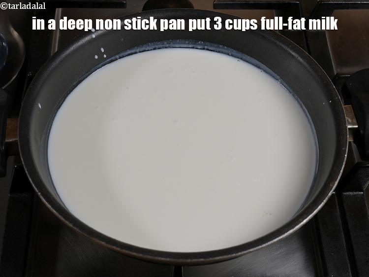 Step 7 – In a deep non stick pan put&nbsp;3 cups&nbsp;full-fat&nbsp;<a href="https://www.tarladalal.com/glossary-milk-doodh-full-fat-milk-buffalo-milk-full-cream-milk-514i">milk</a>.