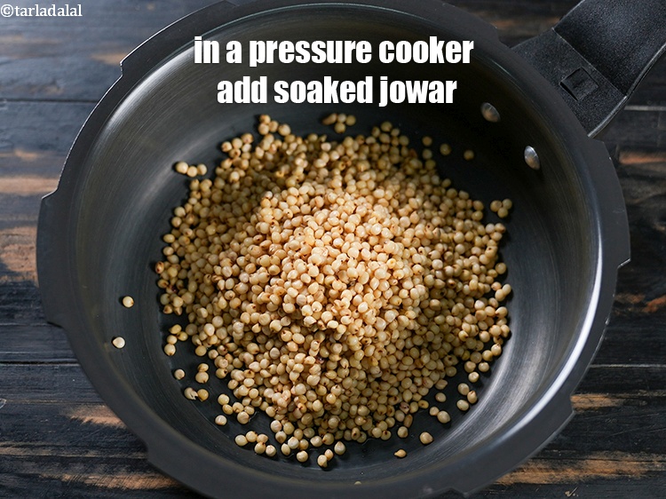 Step 6 – In a pressure cooker add the soaked jowar.&nbsp;