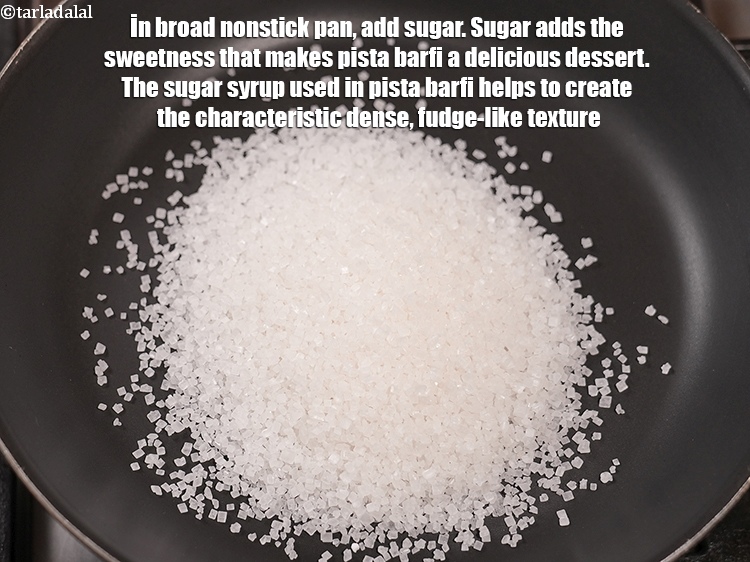 स्टेप 6 – चौड़े नॉनस्टिक पैन में &nbsp;कप&nbsp;<a href=""https://www.tarladalal.com/glossary-sugar-chini-shakkar-hindi-278i"">चीनी</a>&nbsp;डालें। चीनी पिस्ता बर्फी को …