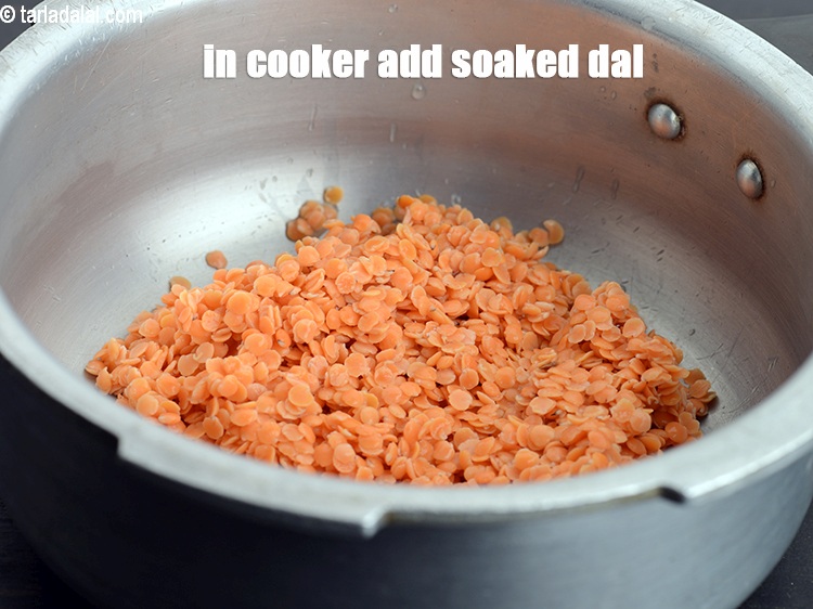 Step 6 – In the pressure cooker add soaked masoor dal.