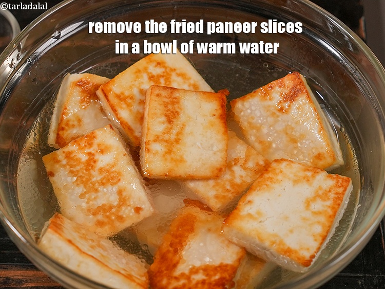 Step 6 – Remove the fried paneer slices in a bowl of 1&frac12; cups of warm water. Keep …