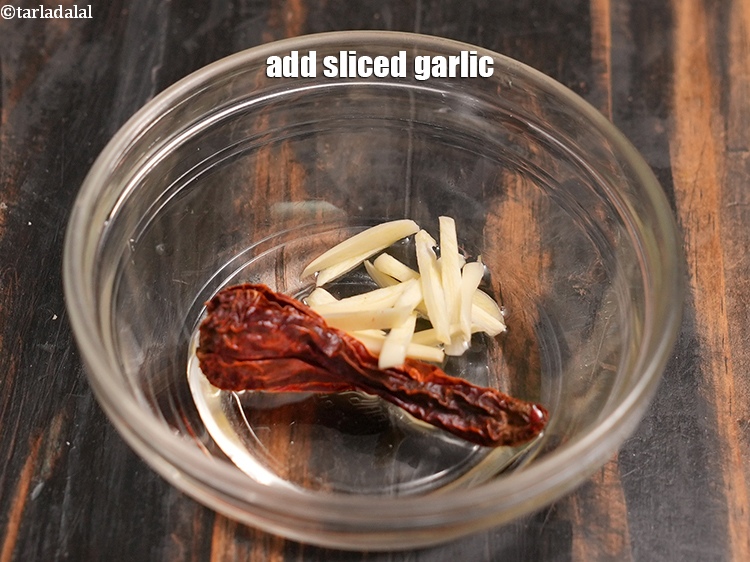 Step 42 – Add 1 tsp <a href="https://www.tarladalal.com/glossary-sliced-garlic-773i">sliced garlic (lehsun)</a>.