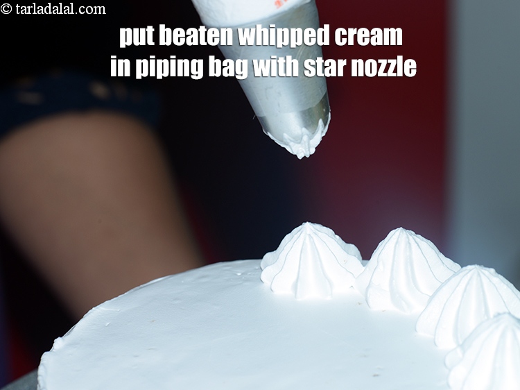 Step 49 – Put the beaten whipped cream in a piping bag with a star nozzle fitted in.
