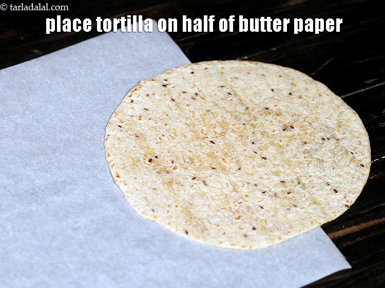 Step 43 – Place a tortilla on the half of the butter paper.&nbsp;