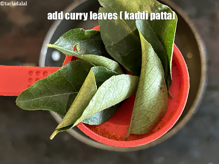 Step 44 – <html><head></head><body><p>Add&nbsp;4 to 5&nbsp;<a href="glossary-curry-leaves-kadi-patta-kadipatta-388i">curry leaves (kadi patta)</a>.</p></body></html>