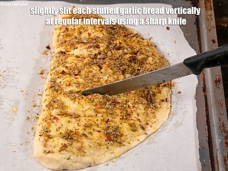 Step 44 – Slightly slit each stuffed garlic bread vertically at regular intervals using a sharp knife.&nbsp;