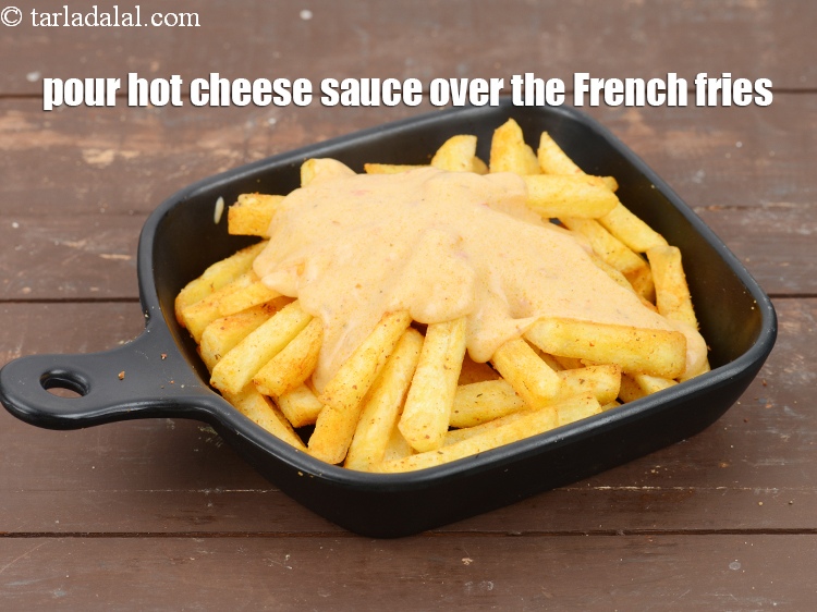 Step 45 – Pour hot cheese sauce over the French fries.