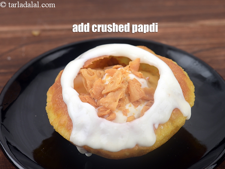 Step 46 – Add 2 tbsp <a href="https://www.tarladalal.com/glossary-crushed-papdi-2274i">crushed papdi</a>.