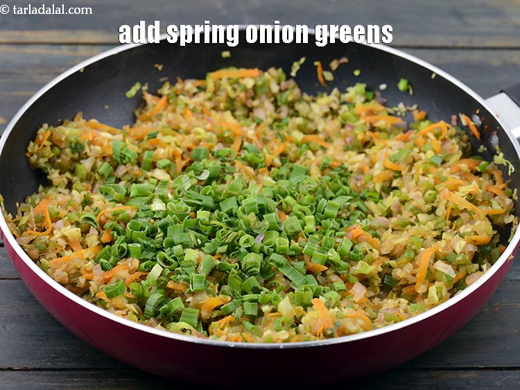 Step 45 – Add the 1/4 cup&nbsp;<a href="https://www.tarladalal.com/glossary-chopped-spring-onion-greens-1030i">chopped spring onion greens</a>&nbsp;and mix well. Keep aside.&nbsp;