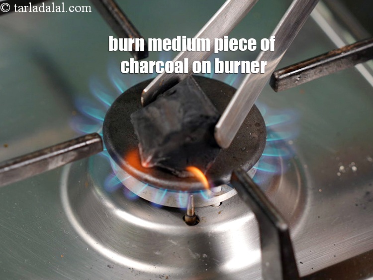 Step 44 – Burn a medium peice of <a href="https://www.tarladalal.com/glossary-charcoal-1950i">charcoal</a>&nbsp;on a burner.&nbsp;