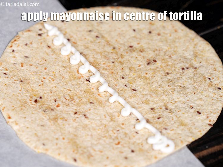 Step 44 – Apply 1 tbsp of &nbsp;<a href="https://www.tarladalal.com/glossary-mayonnaise-505i">mayonnaise</a>&nbsp;in the centre of the tortilla.&nbsp;