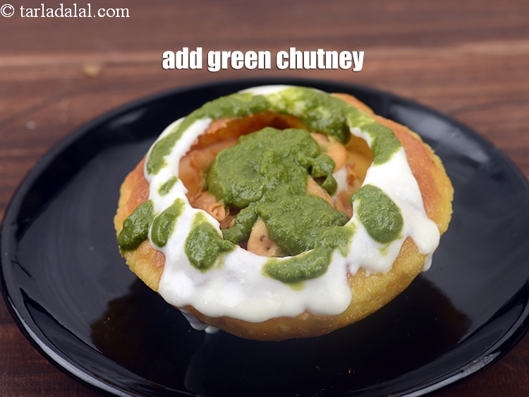 Step 47 – Add 2 tbsp <a href="https://www.tarladalal.com/green-chutney-22266r">green chutney</a> evenly over the kachori.
