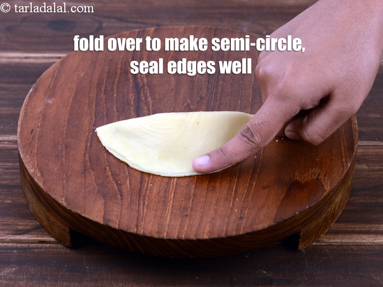 Step 53 – After placing the stuffing, seal the corners of the Karanji well before deep-frying, else the …