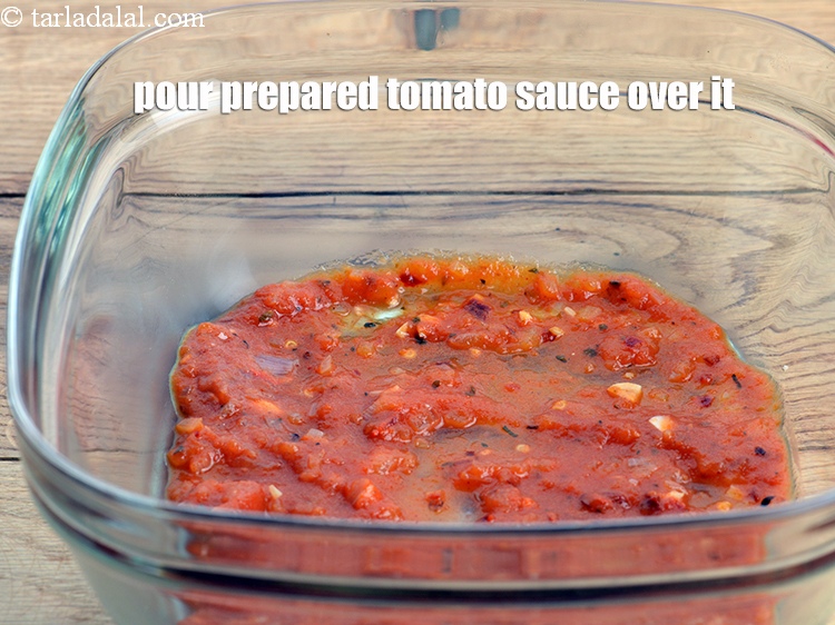 Step 45 – Take a baking square dish. Pour &frac14; cup of prepared tomato sauce evenly over it.