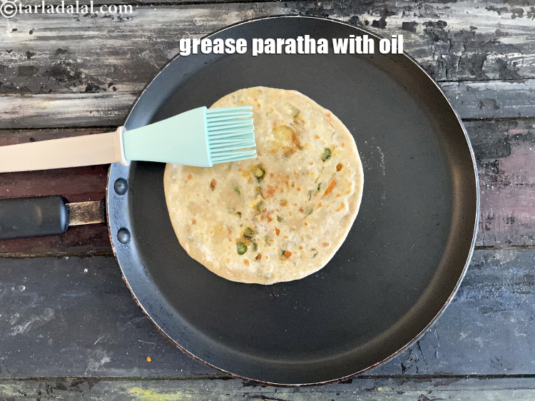 Step 42 – Grease the paratha with oil.