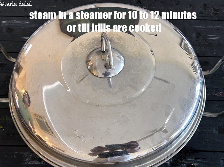Step 22 – Steam in a steamer for 10 to 12 minutes or till the idlis are cooked.