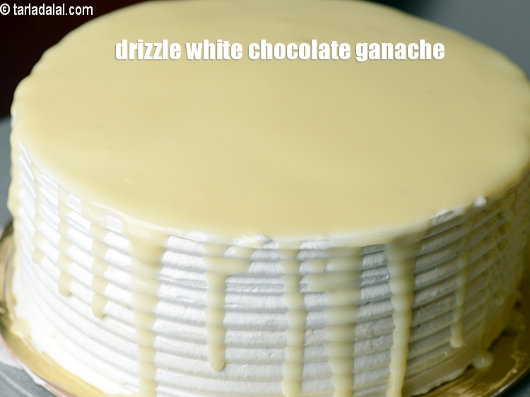 Step 49 – Drizzle the white chocolate ganache on the top.