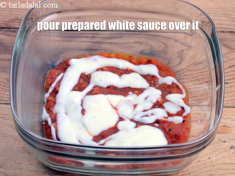 Step 46 – Pour &frac12; cup of prepared white sauce evenly over it.