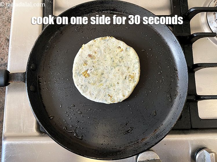 Step 55 – <meta charset="UTF-8" /> Cook one side of&nbsp;paratha for 30&nbsp;seconds on a medium flame.&nbsp;