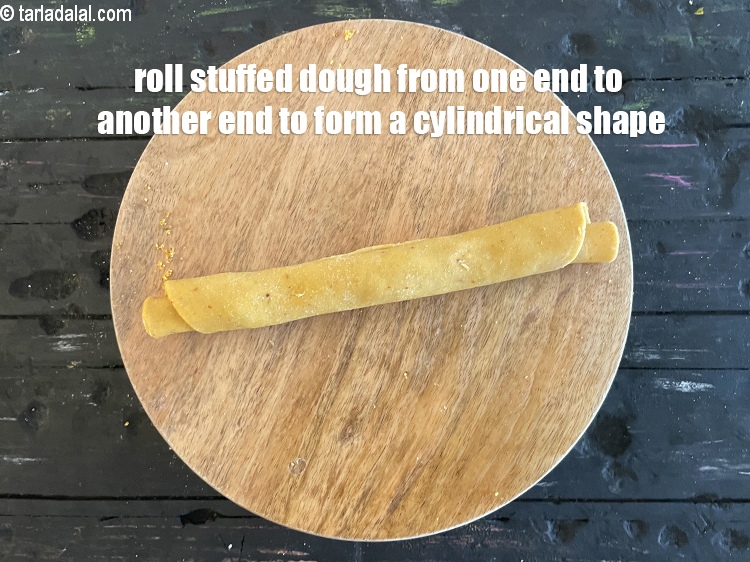 Step 46 – Roll stuffed dough from one end to another end&nbsp;to form a cylindrical roll.