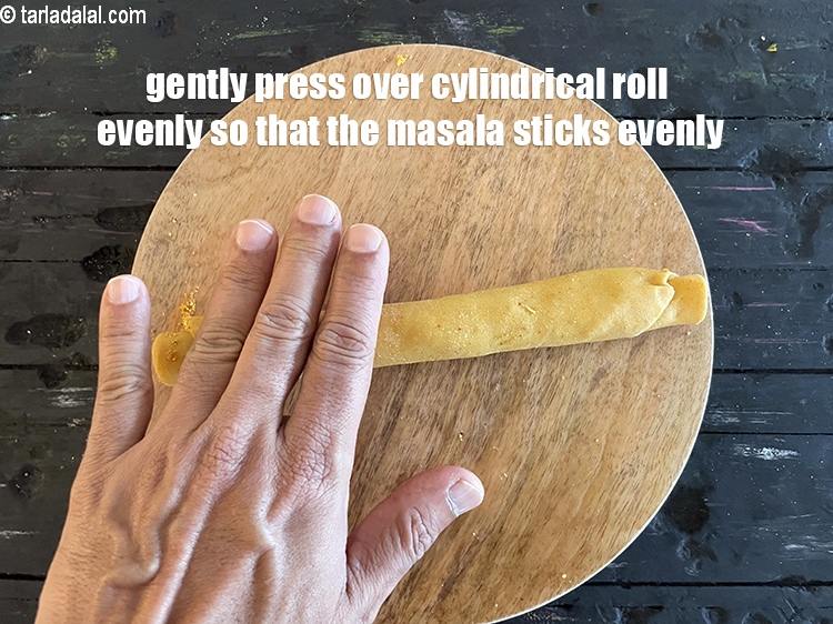 Step 47 – Gently press all over the cylindrical roll evenly so that the masala further sticks to …