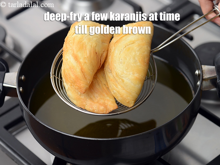 Step 49 – Deep-fry a few karanjis at a time on a medium flame till they turn golden …