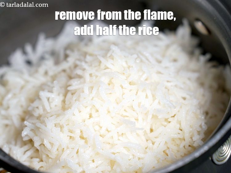 Step 49 – Remove the pan from the flame, add half the rice.
