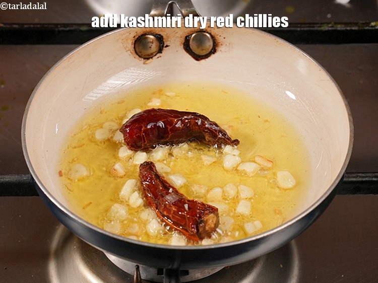 Step 48 – Add 2&nbsp;<a href="https://www.tarladalal.com/glossary-whole-dry-kashmiri-red-chillies-kashmiri-mirch-kashmiri-lal-mirch-332i">whole dry kashmiri red chillies</a>.