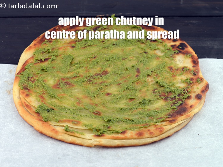 Step 55 – Apply 1 tbsp &nbsp;<a href="https://www.tarladalal.com/green-chutney-22266r">green chutney</a> in the centre of the paratha and spread it …