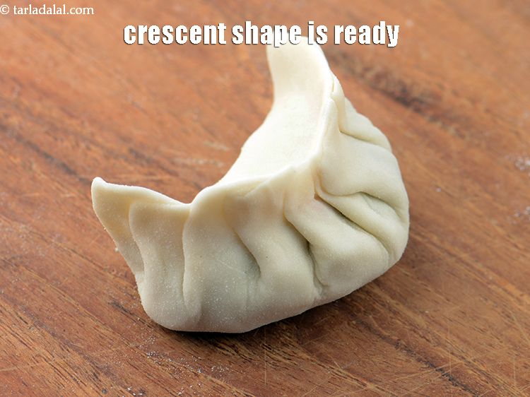 Step 50 – Fold the other open side and pinch it again to form crescent shape as shown …