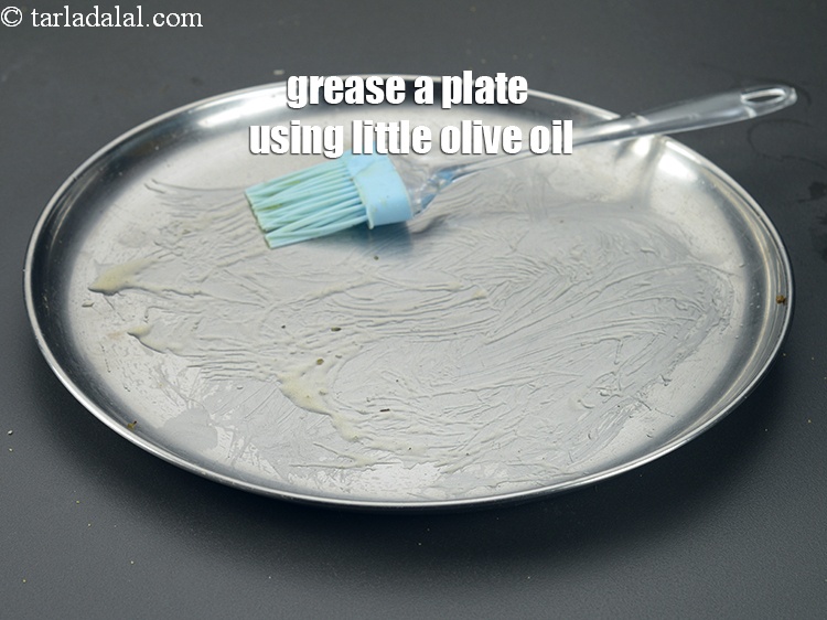 Step 48 – Grease a plate using little <a href="https://www.tarladalal.com/glossary-olive-oil-451i">olive oil</a>.