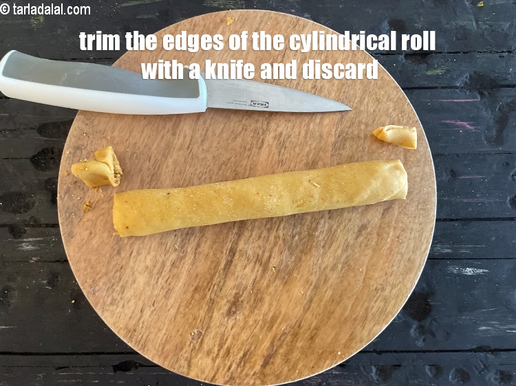 Step 48 – Trim a small portion from both the sides of the cylindrical roll and discard them.