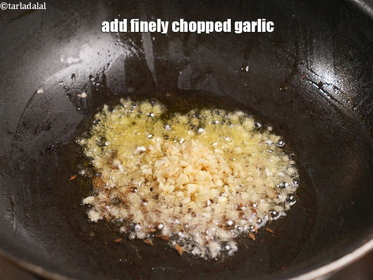 Step 49 – Add 1 tbsp finely <a href="https://www.tarladalal.com/glossary-chopped-garlic-790i">chopped garlic (lehsun)</a>.