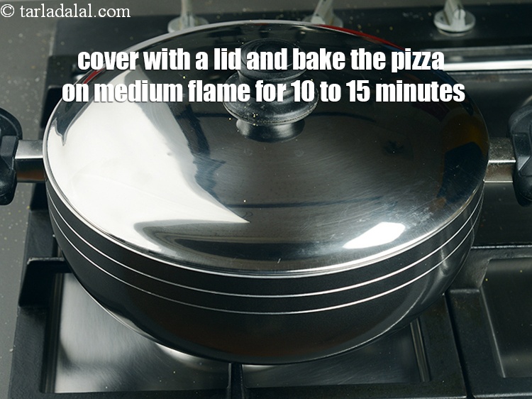 Step 50 – Cover with a lid and bake the pizza on medium flame for 10 to 15 …