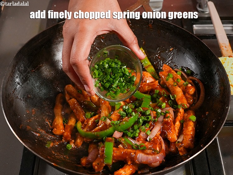 Step 50 – Add &frac14; cup finely <a href="https://www.tarladalal.com/glossary-chopped-spring-onion-greens-1030i">chopped spring onion greens</a>.